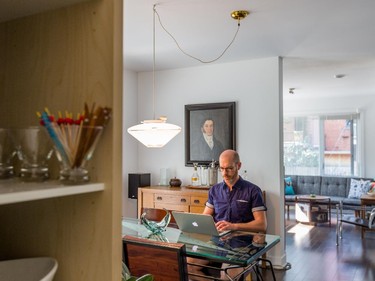 Bernard Dubreuil works on his computer in his dining room at his home in the Plateau-Mont-Royal in Montreal on Wednesday, August 19, 2015. (Dario Ayala / Montreal Gazette)