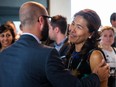 Suspended president of the Quebec Bar Association Lu Chan Khuong, right, greets supporters before a special assembly for the Quebec Bar Association at the Sheraton Hotel in Laval on Monday, August 24, 2015.