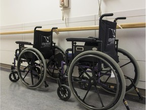 Two wheelchairs in a hospital hallway.