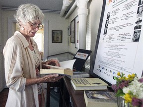 Audrey Wall, executive director of the Greenwood  Centre in Hudson looks at books by some of the authors who have read at the literary festival in the past.