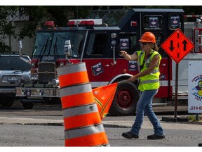 Roadwork projects: A worker directs traffic on St-Charles Blvd.