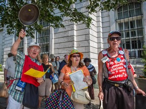 Protesters take part in a demonstration against austerity and in support of social housing outside Montreal City Hall on Monday, July 6, 2015.
