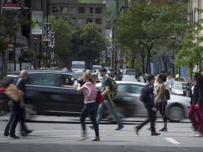 Pedestrians cross Metcalfe street in Montreal on Wednesday, June 10, 2015.