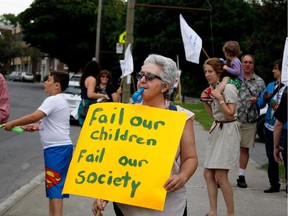 Parents and teaching staff hold a demonstration outside the EMSB head offices in Montreal on Tuesday June 30, 2015. The demonstration was to protest government cuts to public education.