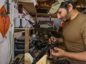 "Wali" was a sniper in the armed forces, who did two tours in Afghanistan and he plans to go to Syria, to fight with the Kurdish Peshmerga against ISIS. "Wali" disassembles a 22-caliber weapon in his work shed.