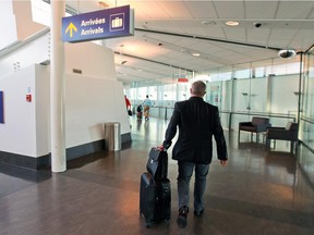 Passengers walk through the international arrivals corridor at Pierre Elliott Trudeau Airport in Dorval. Increasingly, it seems, Montrealers cannot fly direct anywhere without going through Toronto.