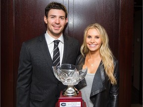 Canadiens goalie Carey Price poses for a photograph with his wife, Angela, in front of Jean Béliveau Trophy at the Bell Centre in Montreal on Oct. 4, 2014.