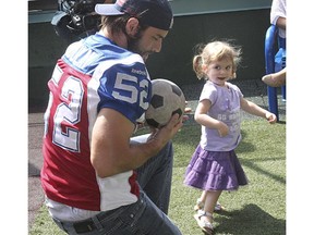 MONTREAL, QUE.:  SEPTEMBER 02, 2014  -- Alouettes player Nicolas Boulay, left, just caught a soccer ball thrown by an unidentified external patient at the Montreal Children Hospital on Tuesday. Alouettes players were visiting sick children on Tuesday afternoon as they do annually in three different children hospitals in Montreal.(Marie-France Coallier/ THE GAZETTE) ORG XMIT: 50813