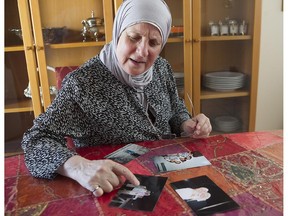 Randa Chahbandar, seen in her Laval home, looks at the last images she has of her and her sister taken in Syria more than eight years ago.
