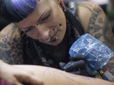 Tatoo artist Karine Tremblay puts down her ink on Rosanne Heller, during the art tattoo show held in Montreal on Friday September 11, 2015. The show at Place Bonaventure goes on through the weekend.