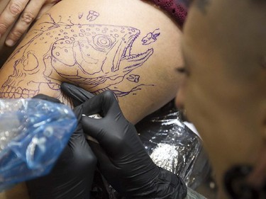 Tatoo artist Karine Tremblay puts down her art on Rosanne Heller during the art tattoo show held in Montreal on Friday September 11, 2015. The show at Place Bonaventure goes on through the weekend.