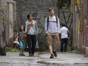 Luc de Montigny, his wife Dao Nguyen and their daughter Sen, walk down an alley leading to Napoléon St. between de l'Hôtel-de-ville and Laval Avenues. The lane, popular with some residents in the area was cleared by a city crew.