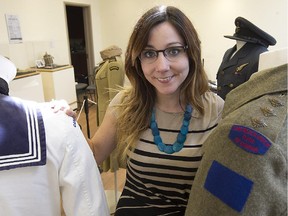 Ashley Clarkson who works at the Dorval Museum of Local History and Heritage, with some of the local war artifacts on display  at the Dorval museum. It will run from Sept. 24 to Nov. 22, commemorating the 70th anniversary of V-E Day. (Pierre Obendrauf / MONTREAL GAZETTE)