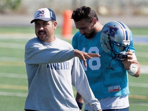 Anthony Calvillo, left, co-offensive coordinator and quarterbacks coach, goes over drills with the team quarterbacks, including Jonathan Crompton, right, during the team practice in Montreal on Friday September 18, 2015.