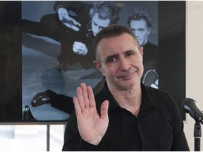 La La La Human Steps artistic director and founder Édouard Lock gives a little wave at the end of a news conference in Montreal Wednesday, Sept. 2, 2015, where he spoke of his decision to bring an end to his troupe.