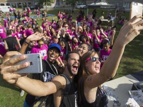 Student leaders take selfies with first-year students (in pink tops) behind at Concordia University on Thursday, Sept. 3, 2015.