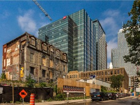 What's left of the Sir Louis-Hippolyte LaFontaine mansion in the residential district of Overdale is dwarfed by modern skyscrapers in downtown Montreal on Wednesday, September 2, 2015.