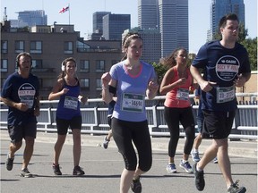 Runners approach the 17 km mark, while running on Notre-Dame St. during the Montreal Marathon on Sunday Sept. 20, 2015. ( / MONTREAL GAZETTE)