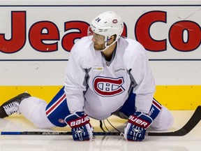 Canadiens defenceman Jarred Tinordi stretches before practice at the Bell Sports Complex in Brossard, on Monday, Sept. 21, 2015.