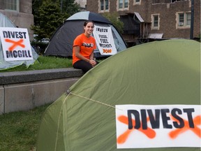 Natasha Way, a McGill Divest organizer, sits in the Community Square at McGill University where Divest McGill has set up a camp in Montreal on Monday September 21, 2015. The group is demanding that the university divest from fossil fuel companies.