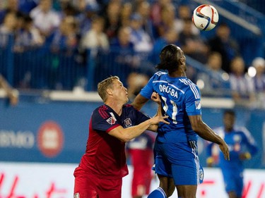 Chicago Fire defender Ty Harden, left, pushes Montreal Impact forward Didier Drogba away from the ball as Drogba heads the ball during MLS action at Saputo Stadium in Montreal on Wednesday September 23, 2015.