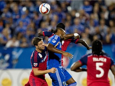 Montreal Impact forward Didier Drogba, centre, gets hit from two side by Chicago Fire plays as he tries to head the ball during MLS action at Saputo Stadium in Montreal on Wednesday September 23, 2015.
