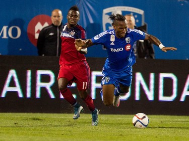 Montreal Impact forward Didier Drogba, right, is tripped by Chicago Fire midfielder David Accam during MLS action at Saputo Stadium in Montreal on Wednesday September 23, 2015.