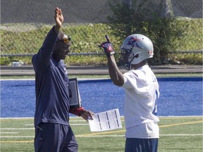 Alouettes special-teams coordinator Kavis Reed, left, with Stefan Logan, during practice in Montreal on Thursday, Sept. 24, 2015. ( Pierre Obendrauf / MONTREAL GAZETTE)