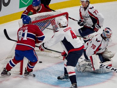 Montreal Canadiens Lars Eller left, watches the puck cross the goal line as Montreal Canadiens centre Alex Galchenyuk rounds the net after scoring against Washington Capitals goalie Braden Holtby during NHL pre-season action in Montreal on Thursday September 24, 2015. Washington Capitals defenceman Taylor Chorney and Washington Capitals right wing T.J. Oshie look on.