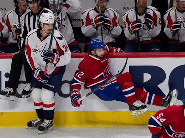 Montreal Canadiens right wing Sven Andrighetto hangs on the boards after being checked by Washington Capital defenceman Jonas Siegenthaler, left, during NHL pre-season action in Montreal on Thursday September 24, 2015.