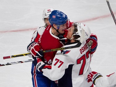 Montreal Canadiens right wing Michael McCarron scuffles with Washington Capitals right wing T.J. Oshie, right, as Washington Capitals left wing Andre Burakovsky holds McCarron back during NHL pre-season action in Montreal on Thursday September 24, 2015.