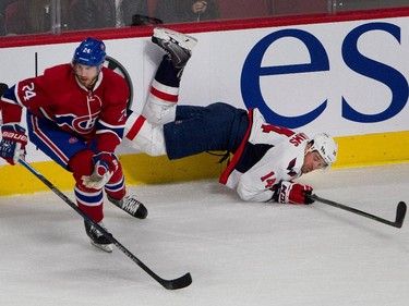 Washington Capitals right wing Justin Williams grimaces as he hits the ice after being checked by Montreal Canadiens defenceman Jarred Tinordi during NHL pre-season action in Montreal on Thursday September 24, 2015.