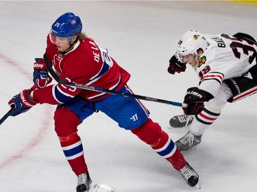 Chicago Blackhawks right wing Kyle Baun tries to hold back Montreal Canadiens left wing Jacob De La Rose during NHL pre-season action in Montreal on Friday September 25, 2015.