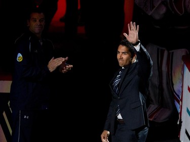 Francis Bouillon waves to the crowd as the Montreal Canadiens announce his retirement from active play during NHL pre-season action against the Chicago Blackhawks in Montreal on Friday September 25, 2015.