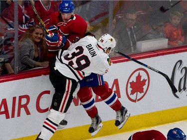 Montreal Canadiens Brett Lernout is driven into the boards by Chicago Blackhawks right wing Kyle Baun during NHL pre-season action in Montreal on Friday September 25, 2015.