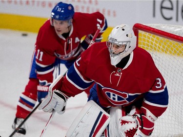 Montreal Canadiens goalie Zachary Fucale, right, watches as the team takes shots on him  during the pre-game warmup skate during NHL pre-season action against the Chicago Blackhawks in Montreal on Friday September 25, 2015. Montreal Canadiens right wing Brendan Gallagher looks on.