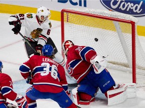 Montreal Canadiens goalie Carey Price looks back into the net as Chicago Blackhawks Garret Ross scores during NHL pre-season action in Montreal on Friday September 25, 2015. Montreal Canadiens Brett Lernout looks on.