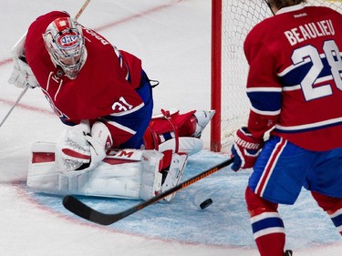Montreal Canadiens goalie Carey Price looks back in his crease after making a pad save against the Chicago Blackhawks during NHL pre-season action in Montreal on Friday September 25, 2015. Montreal Canadiens defenceman Nathan Beaulieu cleared the loose puck.