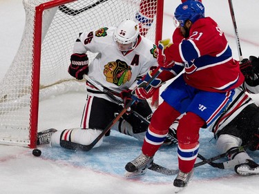 Montreal Canadiens right wing Devante Smith-Pelly is stopped by Chicago Blackhawks left wing Daniel Paillé after Chicago Blackhawks goalie Scott Darling fell to the ice leaving the net open during NHL pre-season action in Montreal on Friday September 25, 2015.