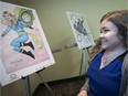 Melissa Bilodeau examines her superhero illustration at the Holiday Inn Montréal-Longueuil that was drawn drawn by Yanick Paquette, a DC comics artist from Montreal on Saturday, Sept. 26, 2015.
