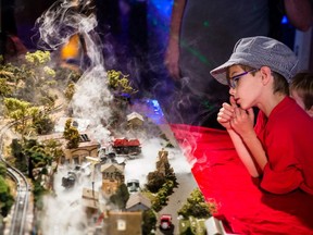 Eight-year-old Émilien Bourassa looks at model trains during the Sun Youth model train exposition and fundraiser in Montreal on Sunday, Sept. 27, 2015.