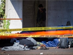 MONTREAL, QUE.: SEPTEMBER 27, 2015 -- Homeless men sleep at Viger Square which was the scene of a stabbing homicide near the corner of St-Denis street and Viger avenue in Montreal on Sunday, September 27, 2015. (Dario Ayala / Montreal Gazette)
