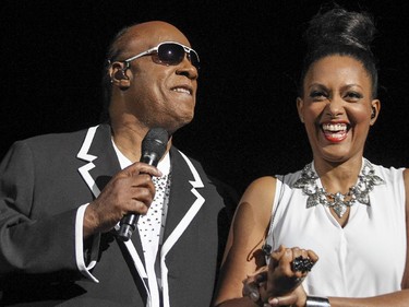 Stevie Wonder is escorted onstage by Wayna Robinson before performing his Songs In the Key of Life album at the Bell Centre in Montreal Wednesday September 30, 2015.
