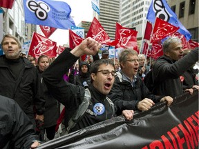 Teachers and supporters march and chant during a demonstration in downtown Montreal, Wednesday Sept. 30, 2015, as part of a day of strikes at French language schools.