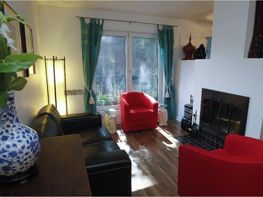 The colourful living room has a fireplace.