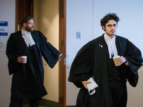 File photo: Tiago murias, right, and Mathieu Brousseau, left, defence lawyers in the case of a teenager facing terrorism charges, leave the courtroom during a break in proceedings at Montreal Youth Court on Wednesday, Sept. 9, 2015.