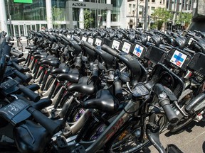 Bixi bicycles at Victoria Square wait to be relocated to cycle stations placed around the city.