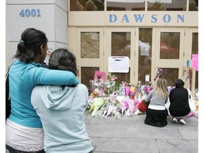 Mourners console each other and leave tributes outside Dawson College Friday Sept. 15, 2006.
