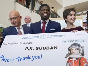 Montreal Canadiens defenceman P.K. Subban, centre, smiles as he poses for the cameras following a press conference at the Children's Hospital in Montreal, Wednesday, September 16, 2015, where he announced that his foundation would pledge $10-million to the hospital.