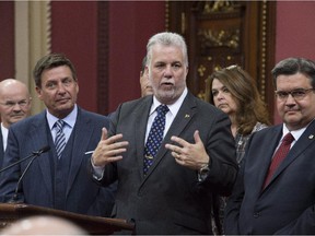 Quebec Premier Philippe Couillard responds to reporters questions over the signature of a fiscal pact with municipalities, Sept. 29, 2015 at the legislature in Quebec City.